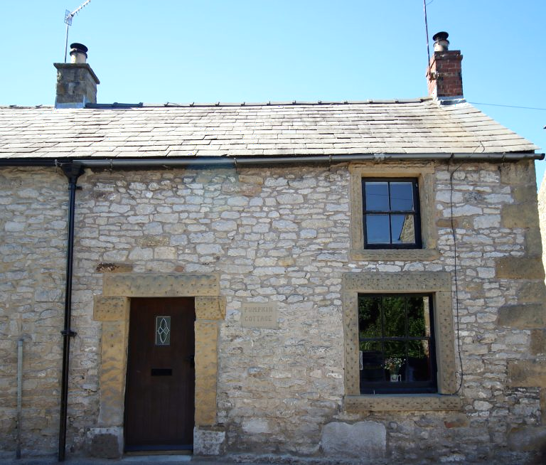 The stone frontage of Pumpkin Cottage